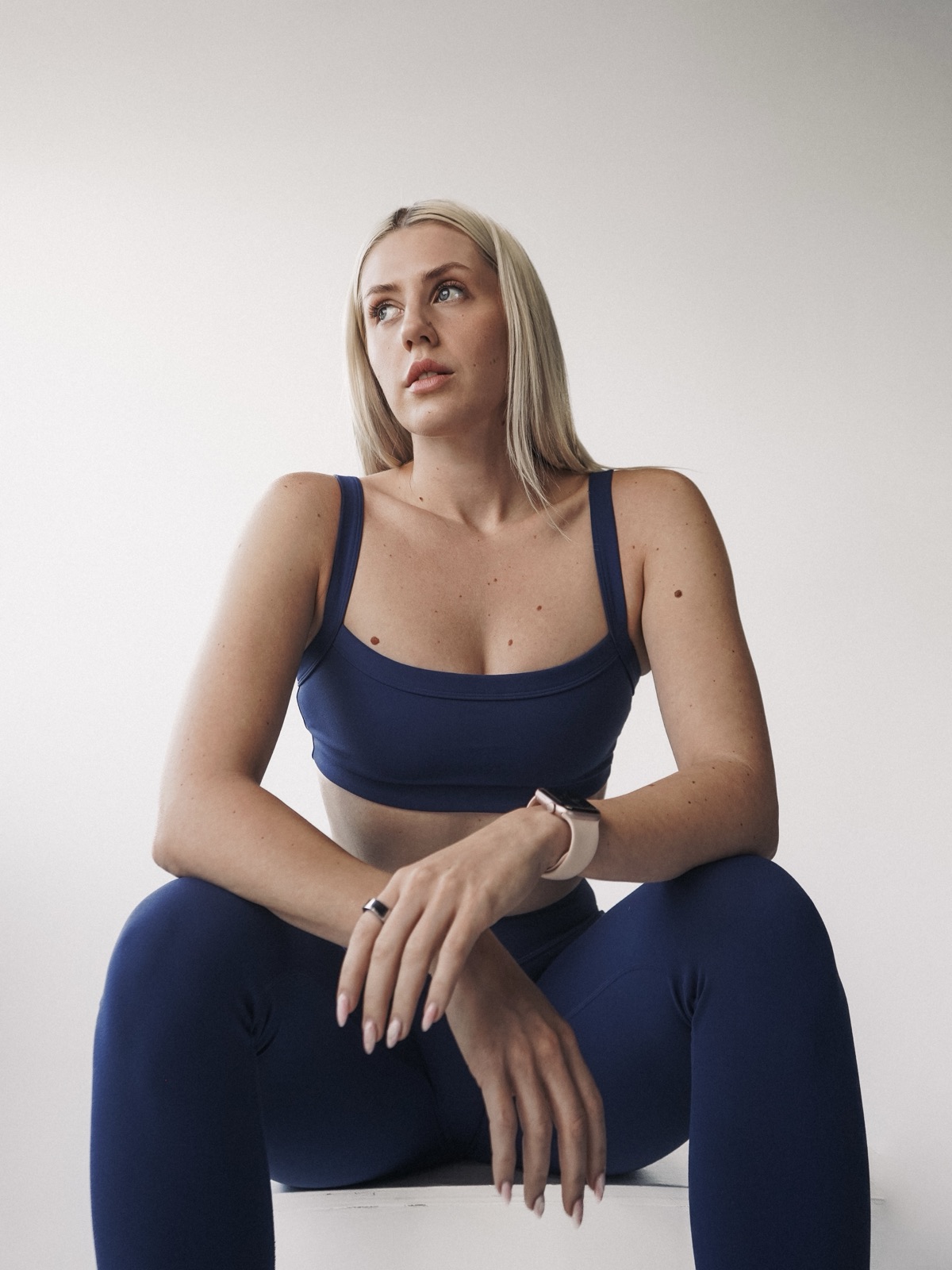 Ida Angelma in navy activewear, seated