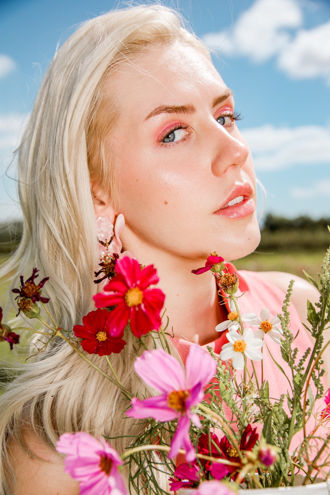 Ida Angelma with wildflowers against a blue sky