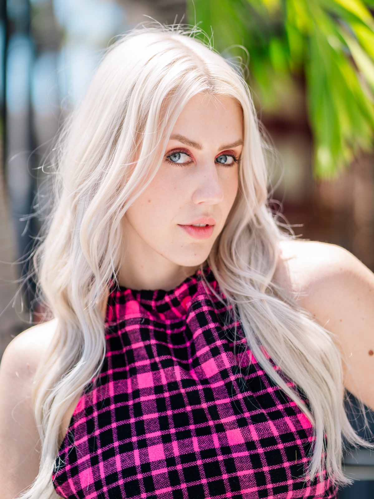 Ida Angelma in a pink plaid halter top outdoors