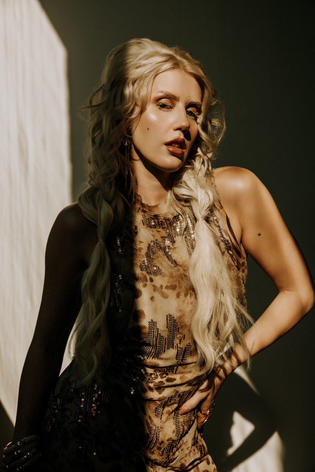 Ida Angelma in a sequined dress, half in shadow