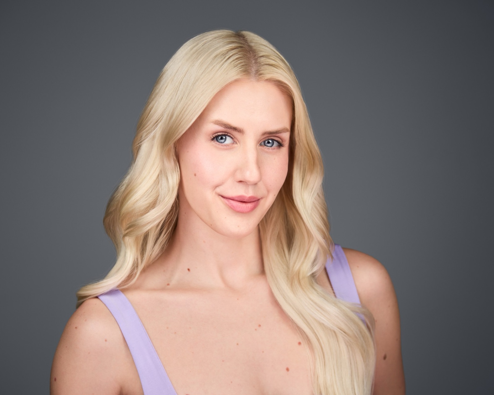 Ida Angelma smiling in a lavender top