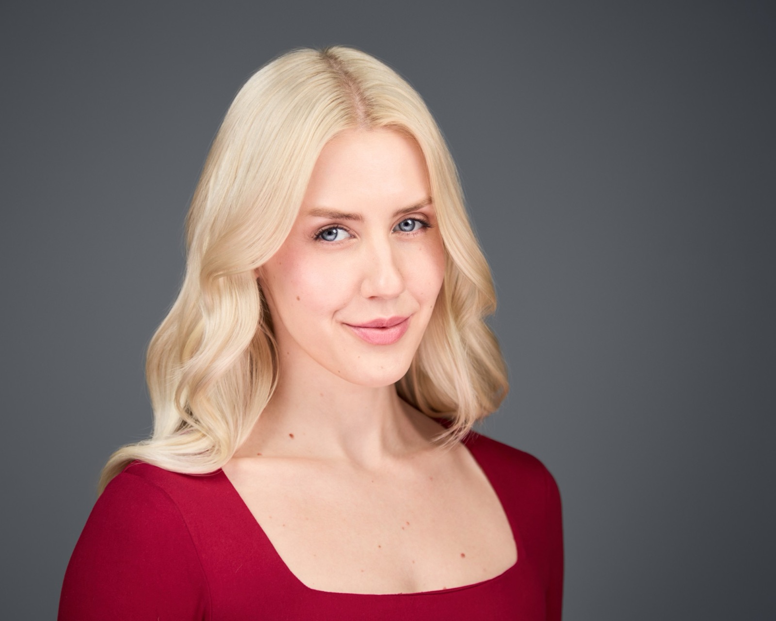 Ida Angelma smiling in a red top
