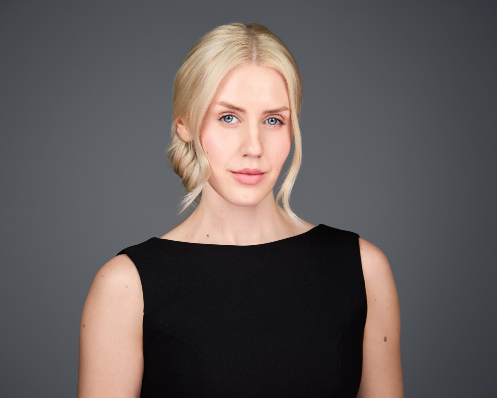 Ida Angelma in a black dress with a low updo