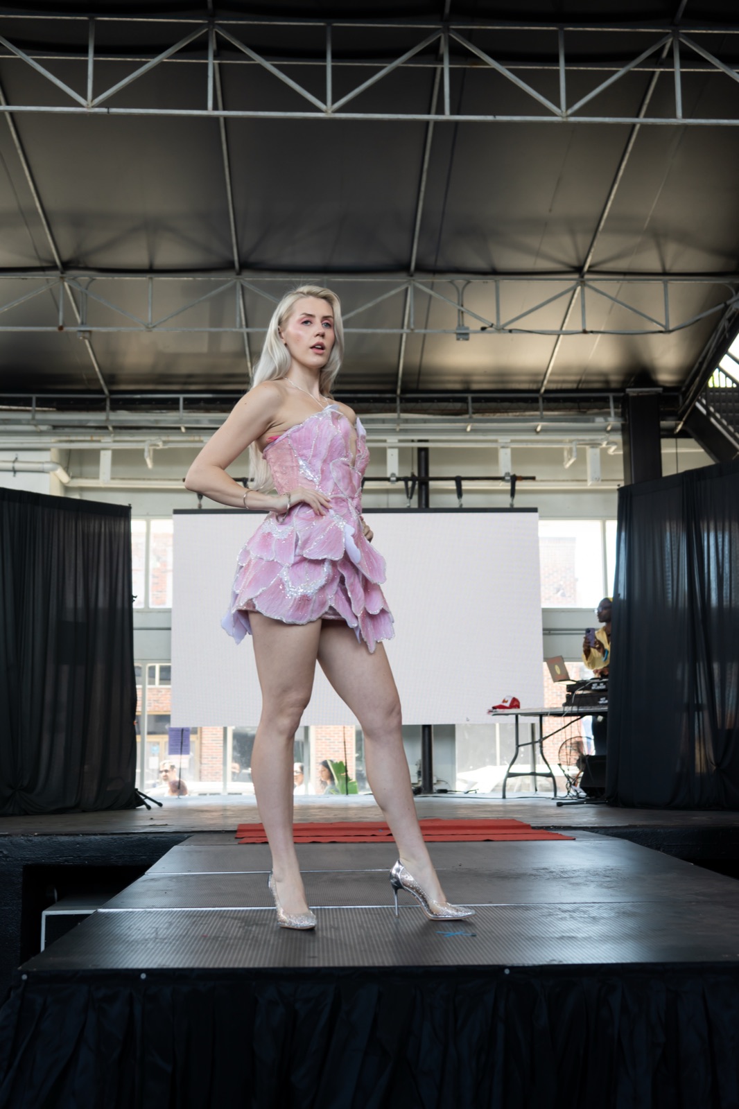 Ida Angelma at the Rebel Wrld Fashion Show in a pink ruffled mini dress